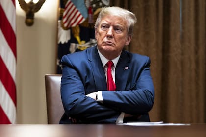 WASHINGTON, DC - APRIL 14: President Donald Trump listens during a meeting with healthcare executives in the Cabinet Room of the White House April 14, 2020 in Washington, D.C. Earlier in the day Trump met with people who had recovered from the coronavirus. During the April 13 Coronavirus Task Force briefing, Trump said the president had "total authority" to reopen the U.S. economy. Doug Mills-Pool/Getty Images/AF