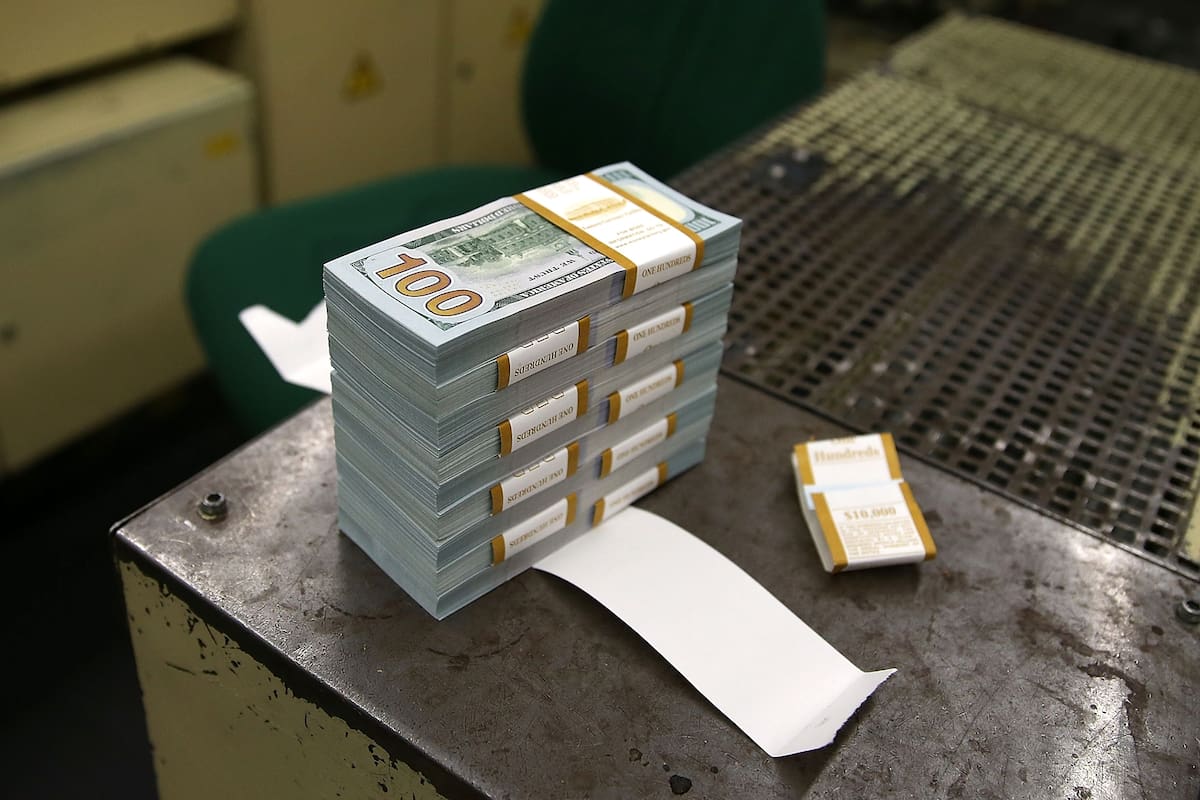 WASHINGTON, DC - MAY 20: A stack of newly redesigned $100 notes sits on a bench at the Bureau of Engraving and Printing on May 20, 2013 in Washington, DC. The one hundred dollar bills will be released this fall and has new security features, such as a duplicating portrait of Benjamin Franklin and mi