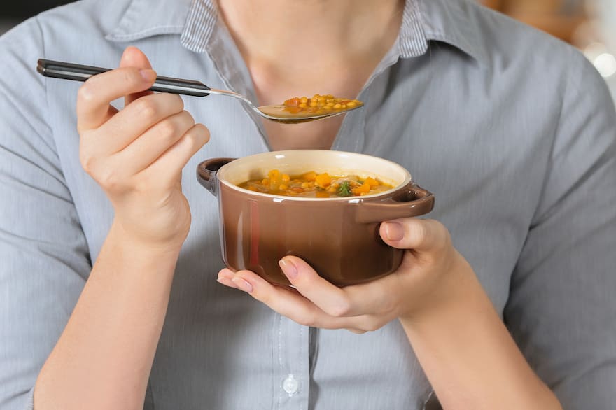 woman-eating-tasty-lentil-soup-ZBWFFBJMRNAWDG4DW6CXBLHHB4