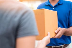 Woman hand accepting a delivery boxes of paper containers from deliveryman,Delivery concept.