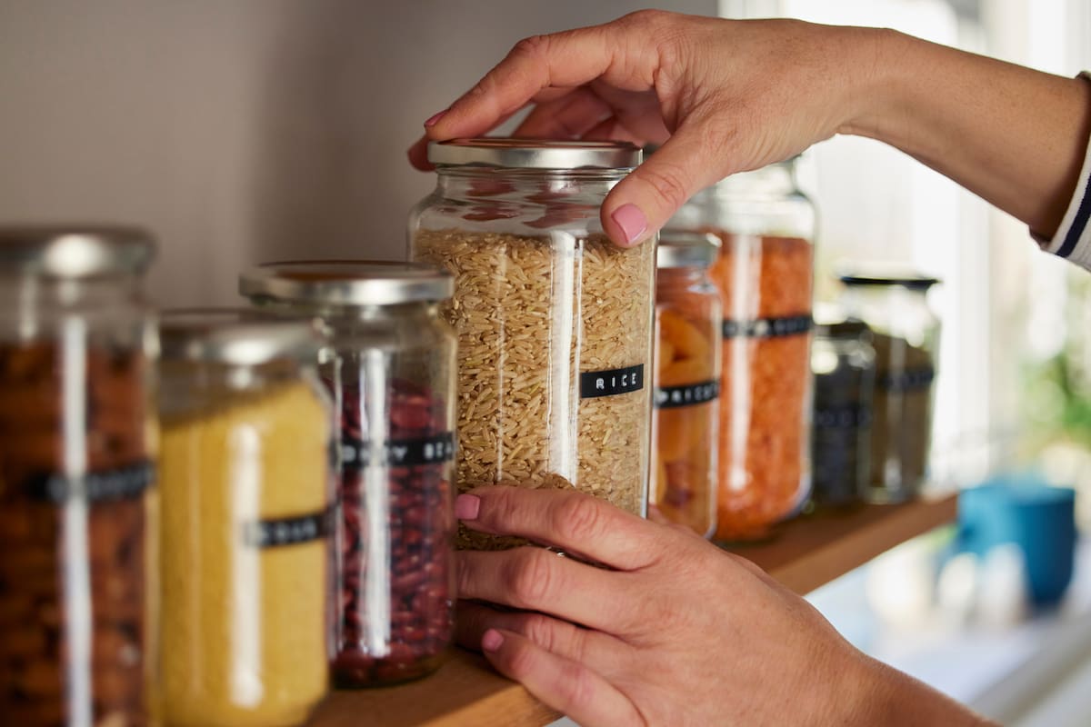 Woman Reusing Glass Jars To Store Dried Food Living Sustainable Lifestyle At Home