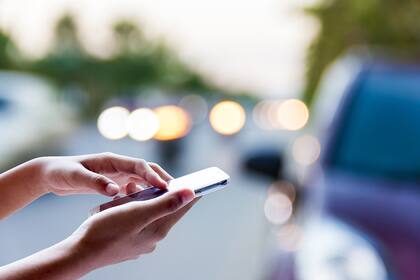 Woman using smart phone for help on the street .