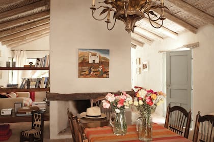 El living y el comedor están divididos por una columna con dos chimeneas, una hacia cada ambiente. El cuadro de la iglesia de Tilcara, de la pintora tucumana Solange Nougués Avellaneda, es un obsequio de la hija de Julio.
