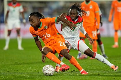 Yan Diomande (izquierda) desborda con el balón ante Issa Kabore, de Burkina Faso, por los octavos de final de la Copa Africana de Naciones