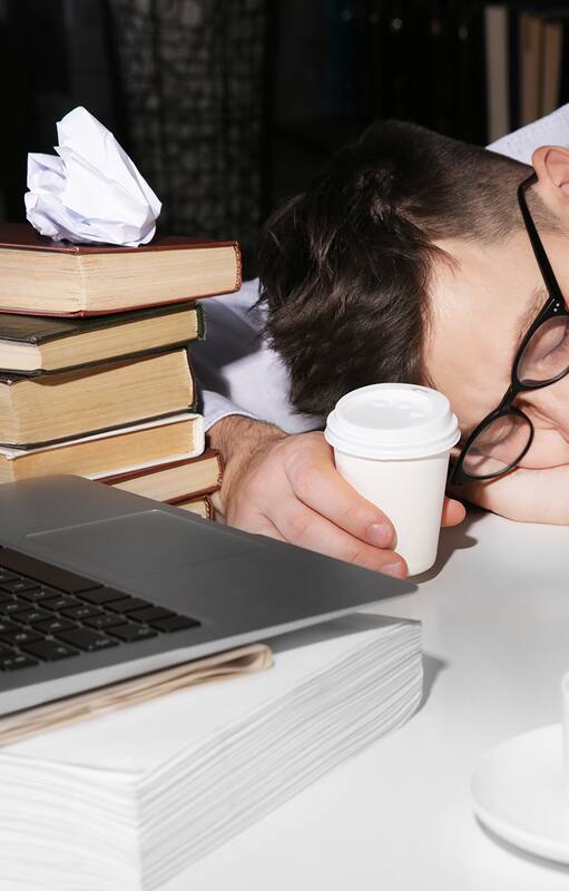 Young man fell asleep during reading at workplace