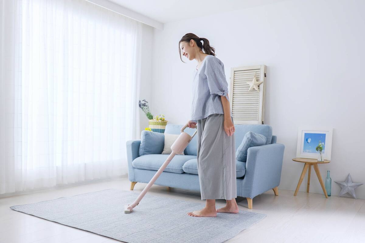 Young woman cleaning the room