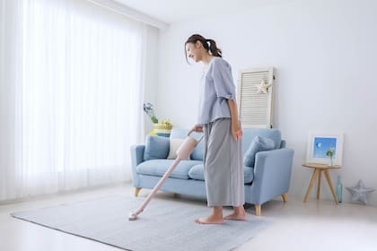 Young woman cleaning the room