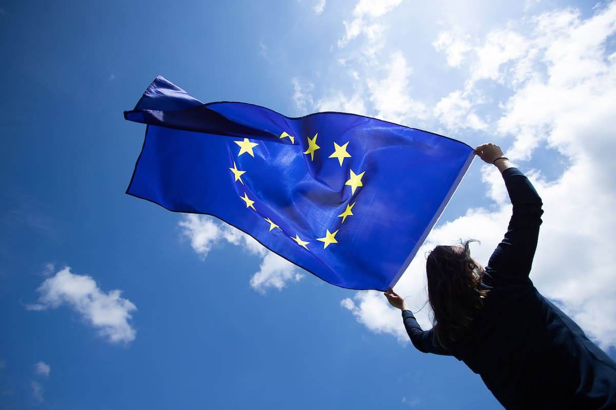Young woman holding European Union flag. Voting, election concept.