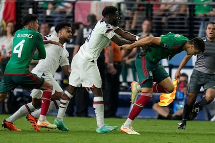 Yunus Musah of the United States pushes Cesar Montes of Mexico during the second half of a CONCACAF Nations League semifinals soccer match Thursday, June 15, 2023, in Las Vegas. (AP Photo/John Locher)