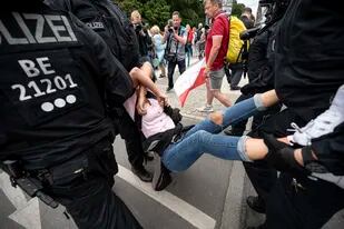 La policía arresta a un manifestante en una manifestación no anunciada en la Columna de la Victoria, en Berlín, el domingo 1 de agosto